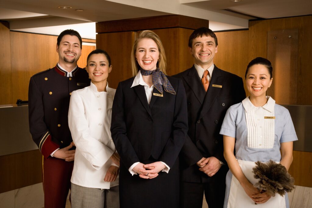 Hospitality industry workers providing excellent customer service at modern hotel front desk