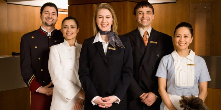 Hospitality industry workers providing excellent customer service at modern hotel front desk