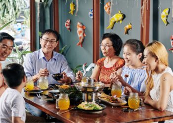 Salo-Salo communal dining tradition with Filipino family sharing meals around festive table