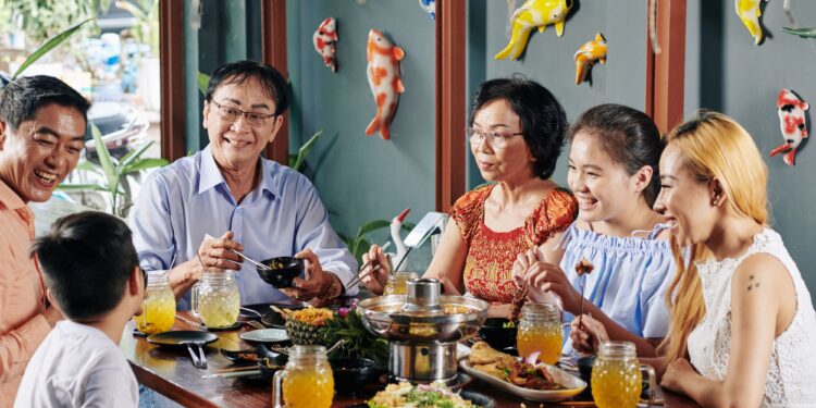 Salo-Salo communal dining tradition with Filipino family sharing meals around festive table