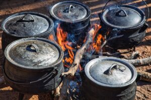 West African one-pot meal in traditional cooking pots