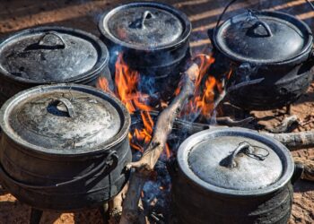 West African one-pot meal in traditional cooking pots