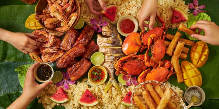 Filipino family enjoying Christmas dinner Noche Buena feast with traditional dishes and celebration