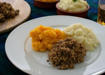 Burns Night haggis with traditional Scottish neeps and tatties on authentic dinner plate