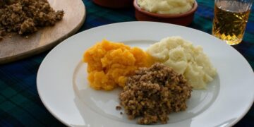 Burns Night haggis with traditional Scottish neeps and tatties on authentic dinner plate