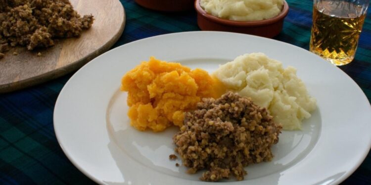 Burns Night haggis with traditional Scottish neeps and tatties on authentic dinner plate