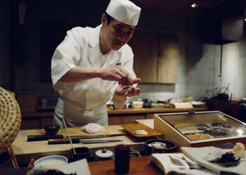 professional chef spreads miso paste onto a fillet in akitchen, showcasing miso as a versatile umami ingredient beyond soup.