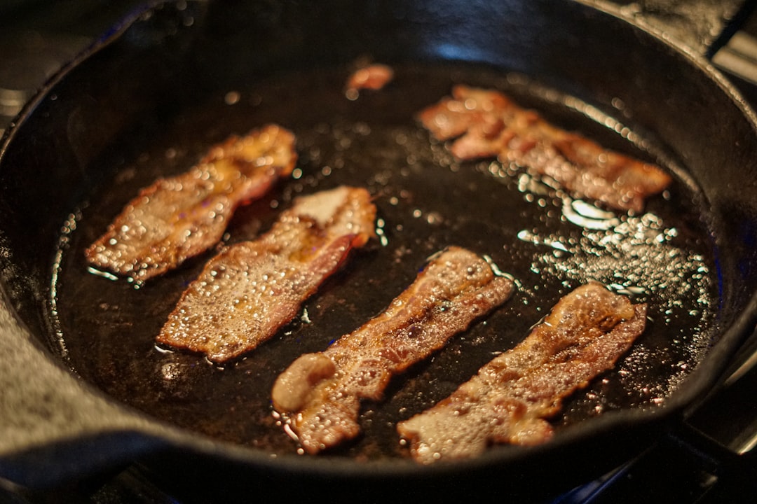 A home cook sears large cuts of meat in a cast iron pan, the first step in preparing a proper Neapolitan ragù