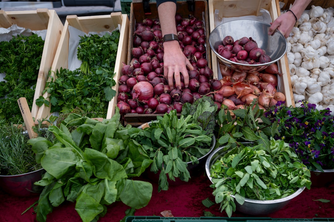 A woman selecting seasonal vegetables at a market to build a nutritious grain bowl at home