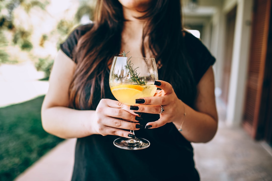 A woman holding a glass of tepache, one of the oldest fermented drinks  made from pineapple rind and warm spices.