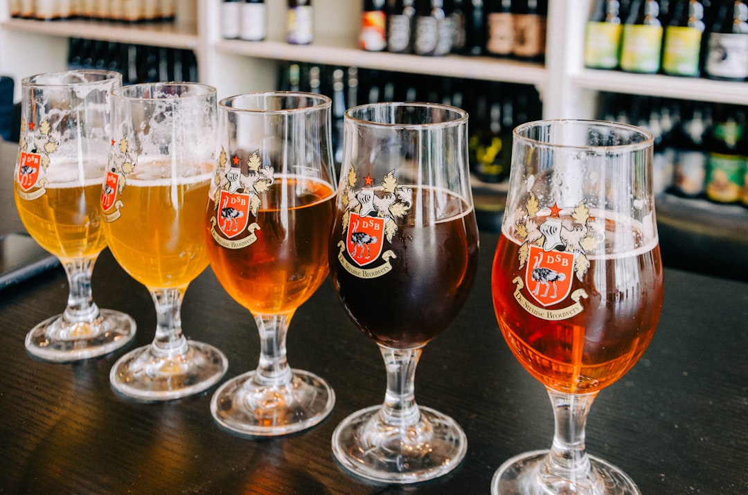 Glasses of Belgian craft beer on a bar counter, reflecting challenges facing Belgian brewers today