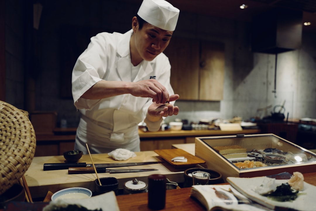 A chef examining a table of global specialty food ingredients sourced from international producers