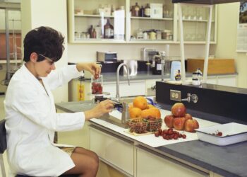 A food scientist examines natural ingredients in a laboratory, reflecting the spirit of food innovation at IFT FIRST