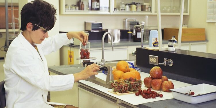 A food scientist examines natural ingredients in a laboratory, reflecting the spirit of food innovation at IFT FIRST