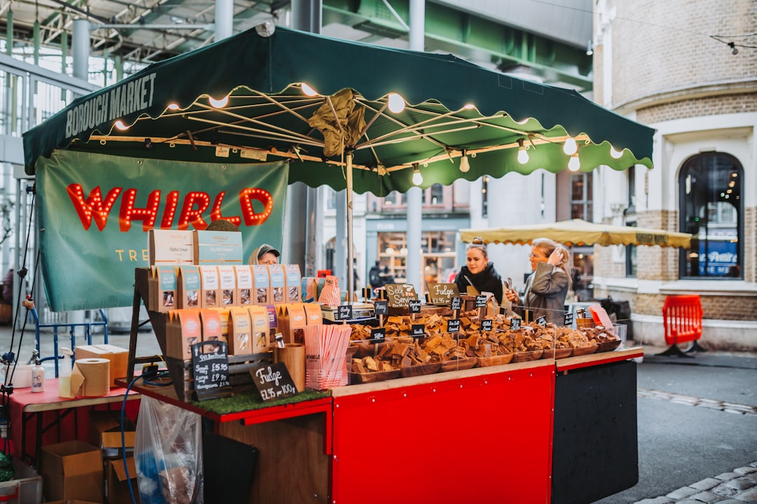 A local artisan producer presents handcrafted goods at an Edinburgh market stall, illustrating the provenance movement.