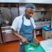 A chef plates a course during service, embodying the deliberate craft behind tasting menus that tell a seasonal story.