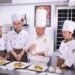 A professional chef presents a finished plate at an international congress