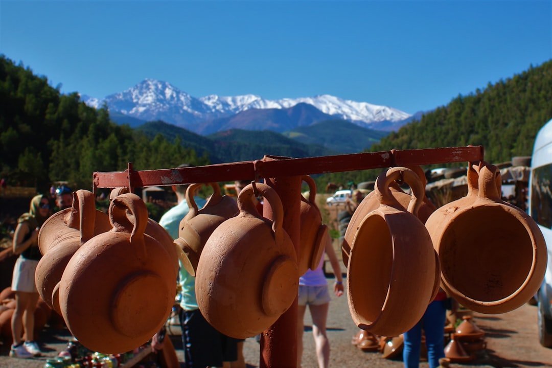 A market vendor displaying handcrafted clay vessels used in traditional Latin American food cultures