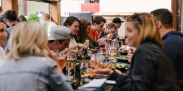 A chef carefully plates a dish for festival visitors, capturing the craft at the heart of British food culture in Edinburgh