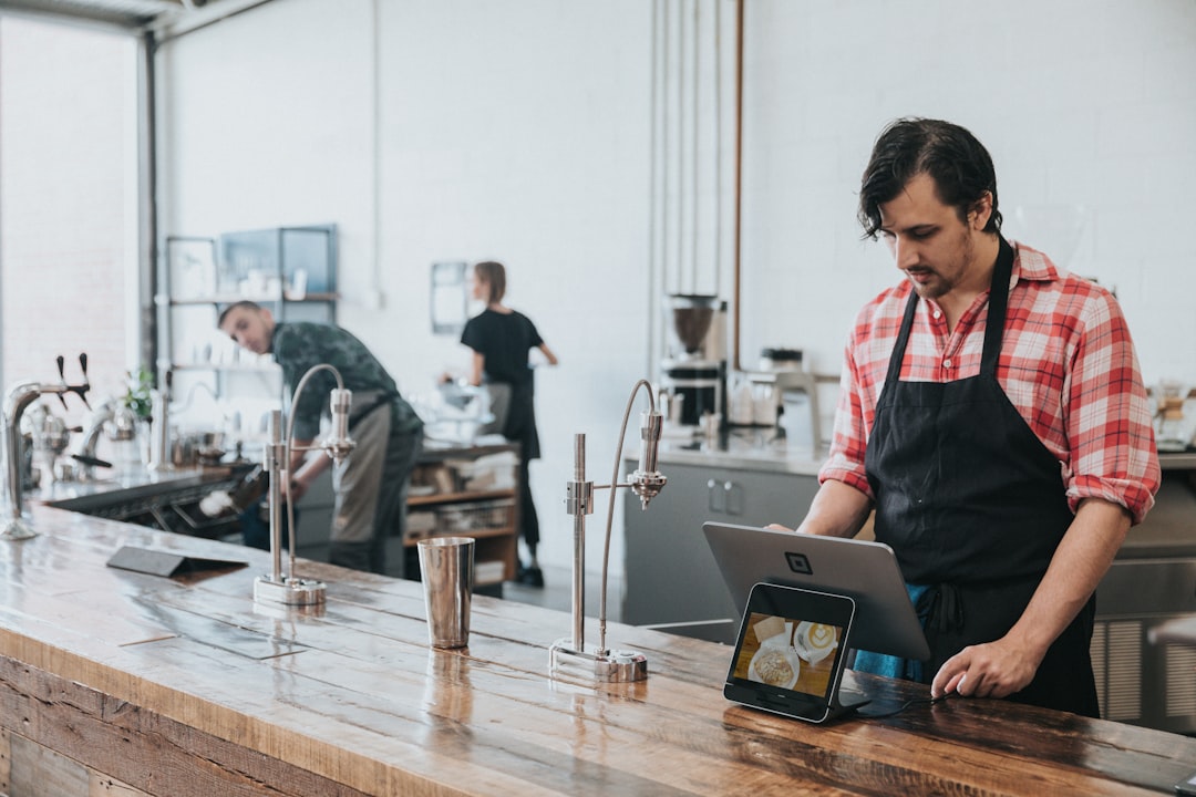 A hospitality manager reviewing performance data on a tablet during a location audit
