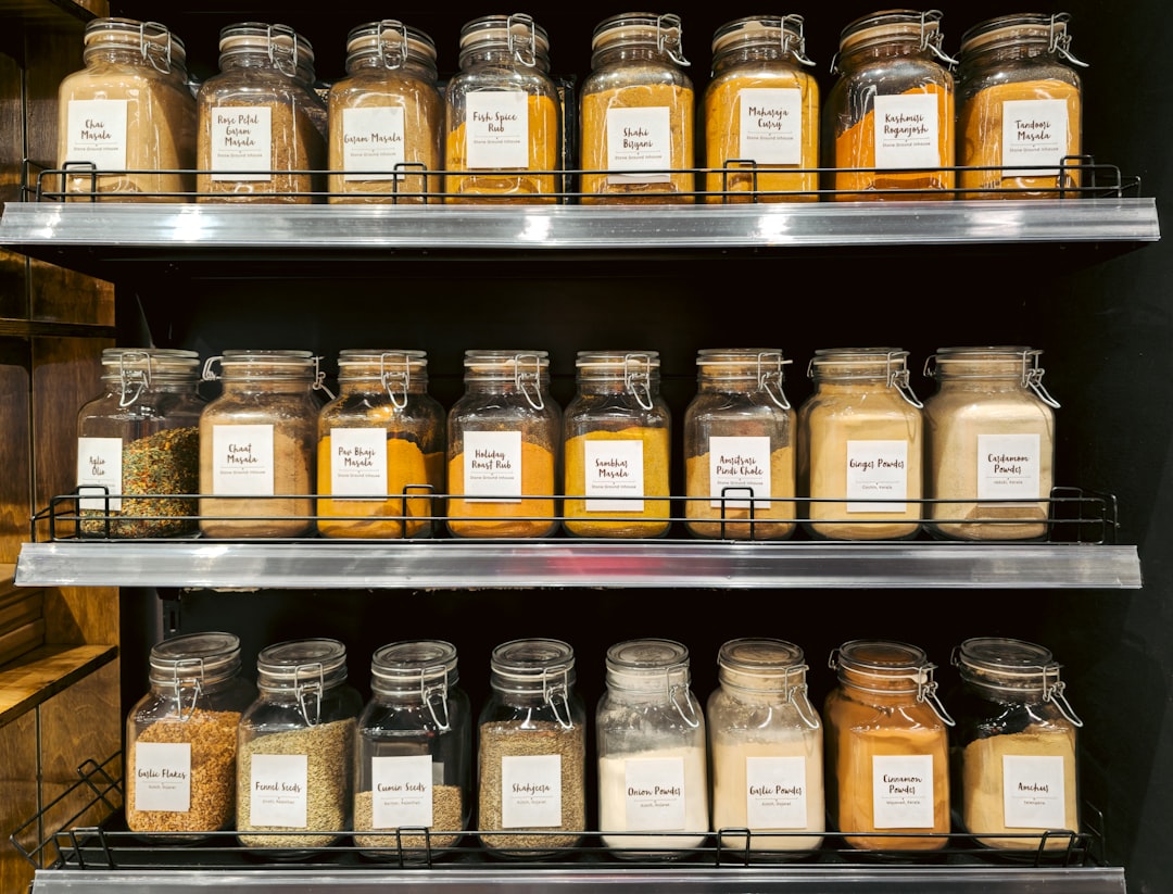 Un cocinero organiza frascos de la despensa con champiñones secos, kombu y salsa de soya, para construir sabor profundo en cualquier receta sin carne.