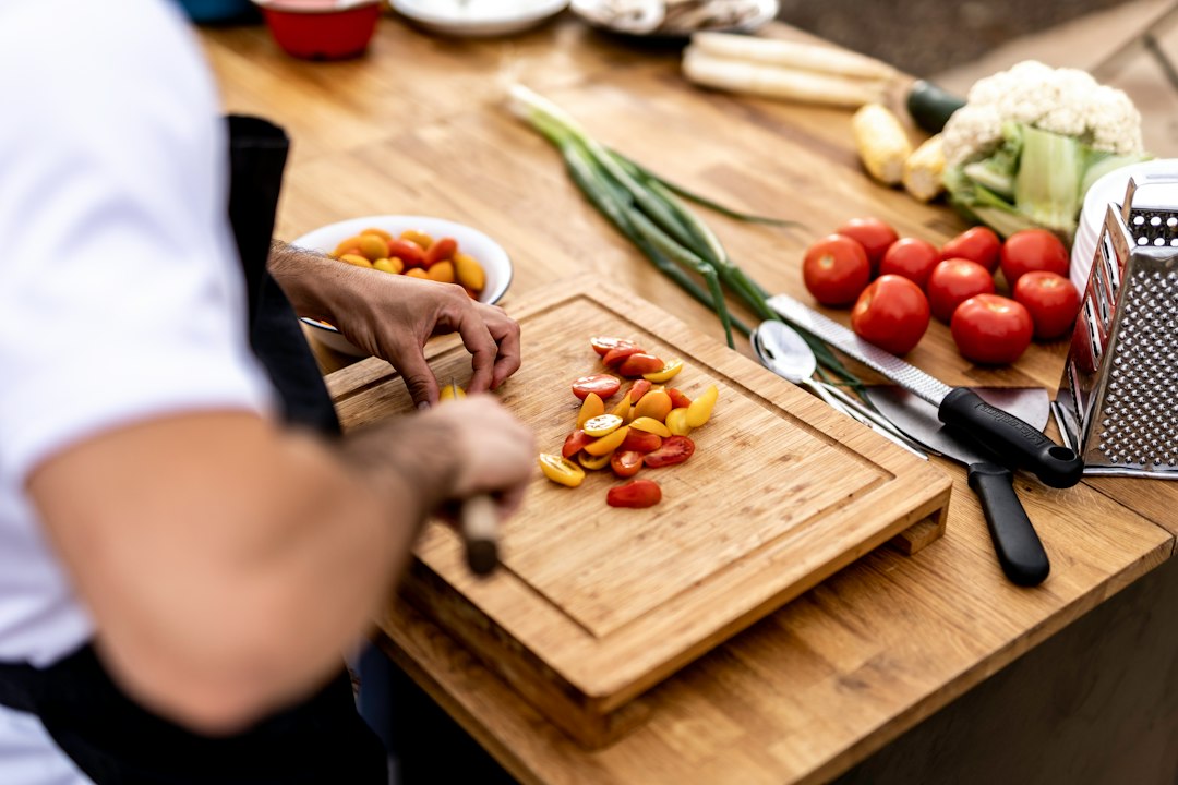A chef inspects fermented ingredients in a restaurant kitchen, a technique central to the evolution  at Gastronomika.