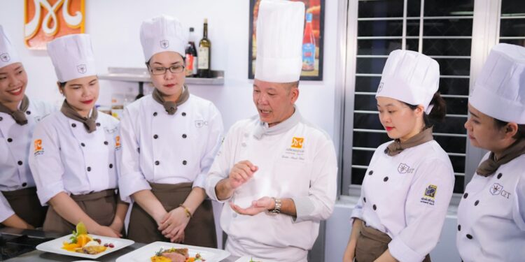 A chef presents a plate at an international culinary congress, like San Sebastian Gastronomika.