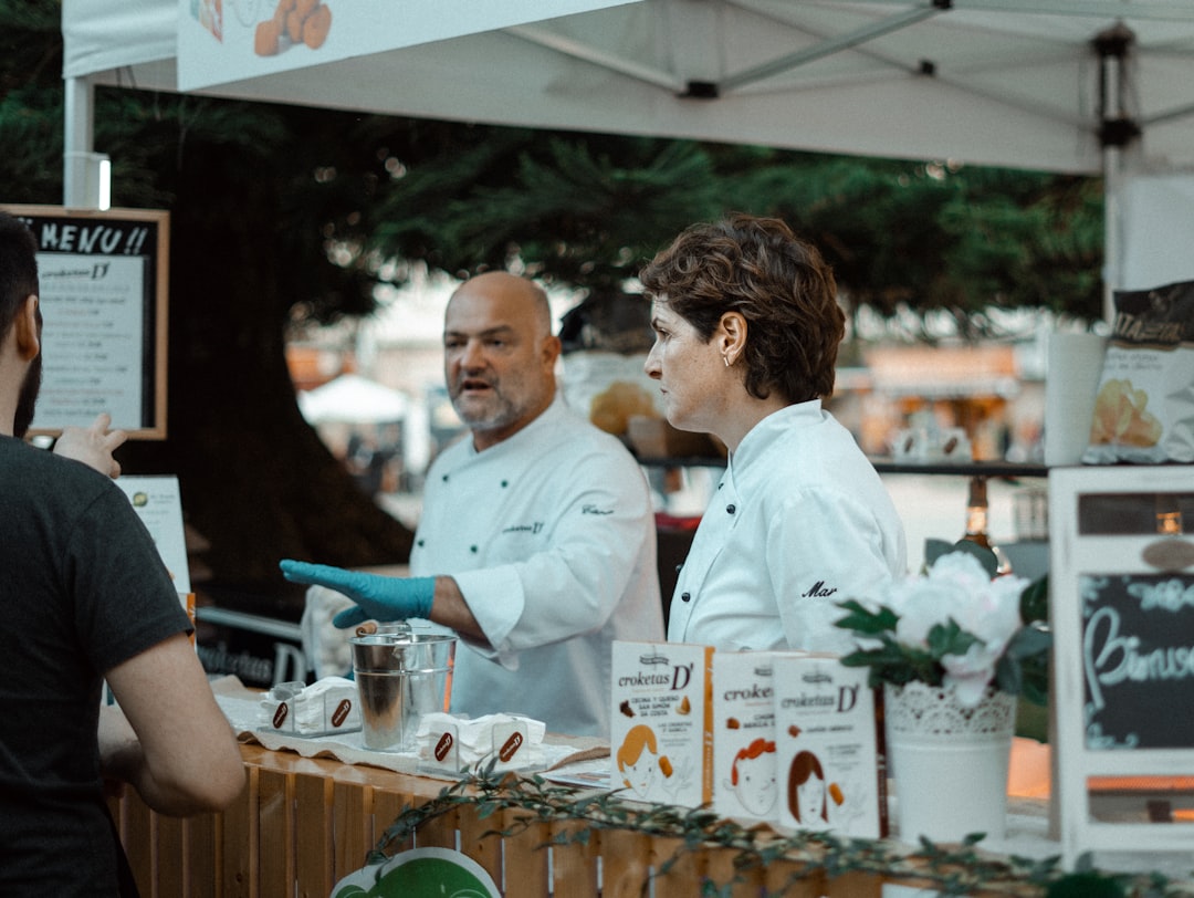 chef tastes locally grown produce at an open-air food festival, connecting to the Terra Madre mission of good and clean food