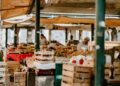 farmer-indigenous-market-food-stall-unsplash - GUSTOwebzine An indigenous producer displays heritage vegetables at a market stall, representing the spirit of Terra Madre.
