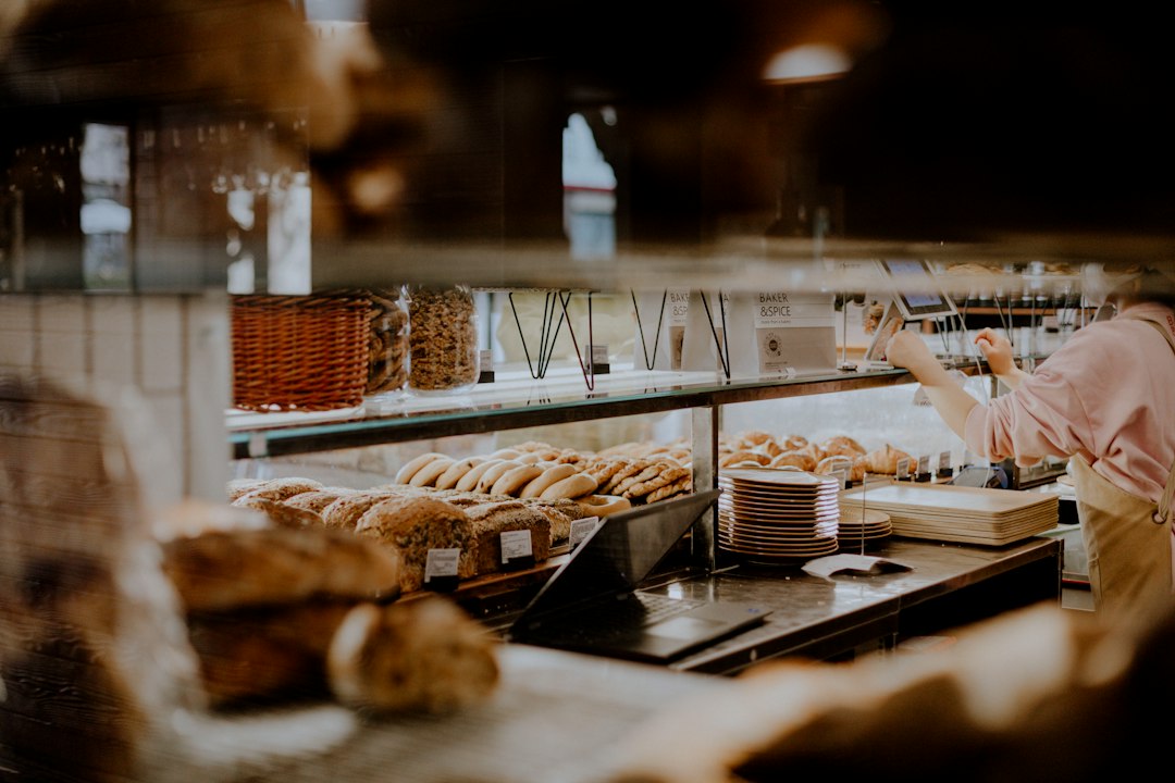 A customer selecting a fresh loaf at a bakery, connecting everyday life to the richness of bread traditions worldwide