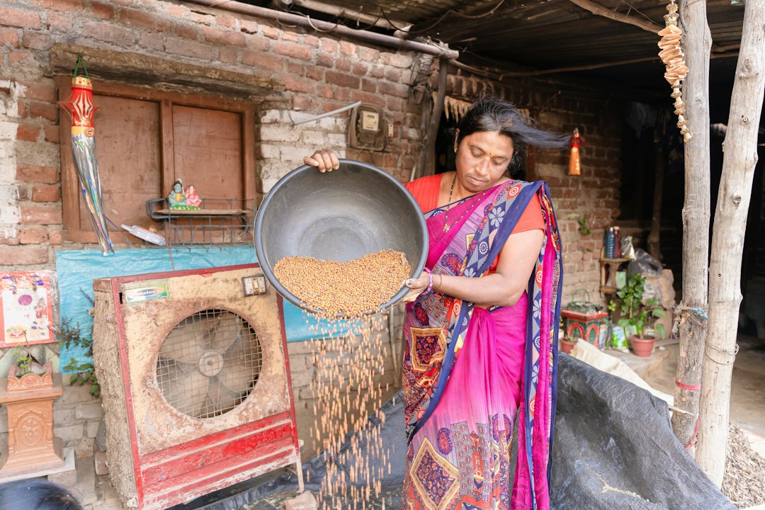 A woman prepares a traditional grain dish outdoors, reflecting the biodiversity celebrated at Terra Madre events worldwide