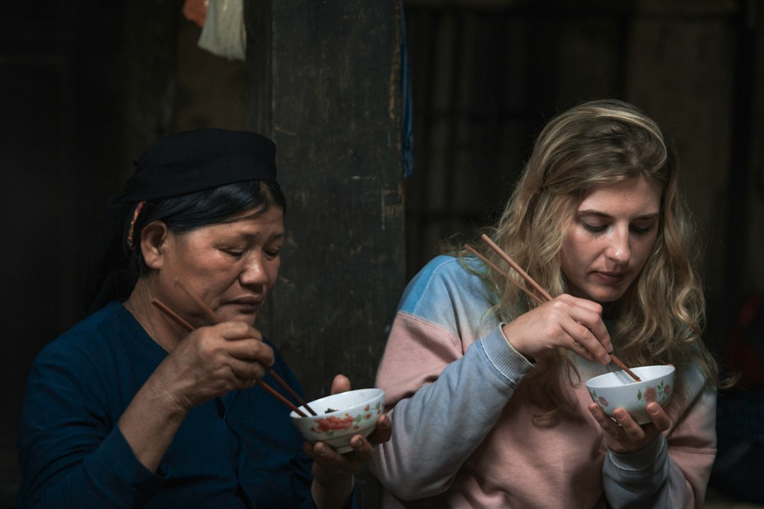 A woman tasting miso paste made through traditional koji fermentation at a food market stall