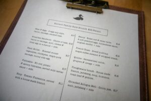 Chef calculating menu pricing for a new dish in a professional kitchen