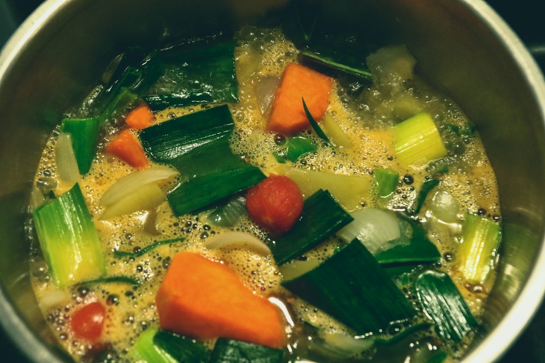 Home cook ladling pumpkin soup into a bowl
