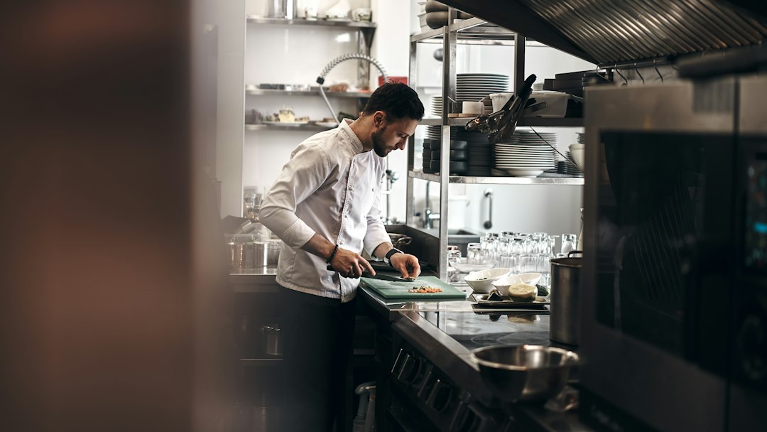 Chef checking a kitchen meter for energy relief savings